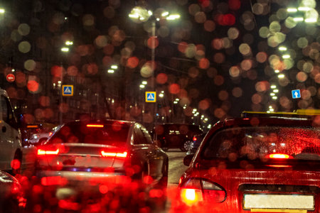traffic jam on the road in the late evening during a rainstorm on the front window of a bad weather car. Journeyの写真素材
