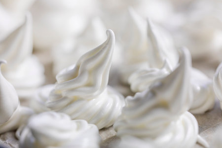 close-up of classic white meringue laid out on foil before baking. Festive moodの写真素材