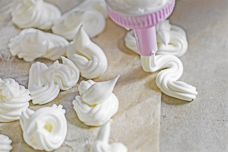 meringue on the tip of a pastry syringe. Cook classic meringue.の写真素材