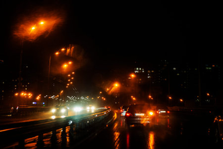 night rainy city with luminous lanterns on a wet road. bad weather