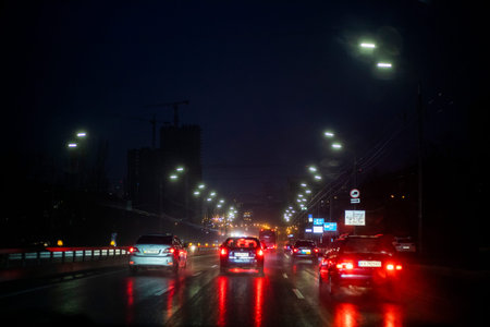 night wet highway in the city illuminated by lanterns. bad weather