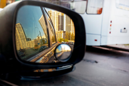 view of the sky in the right side car mirror in the evening at sunset. traffic jam in the city
