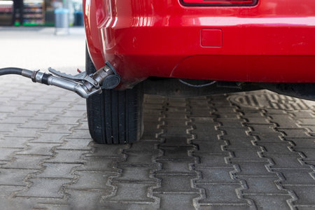 fill the gas filling nozzle of the member side of the car on gas at the gas station during the day. self-service. economic crisis in the worldの写真素材