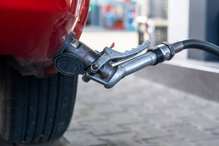 refuel the red car at the gas station during the day. economic crisis