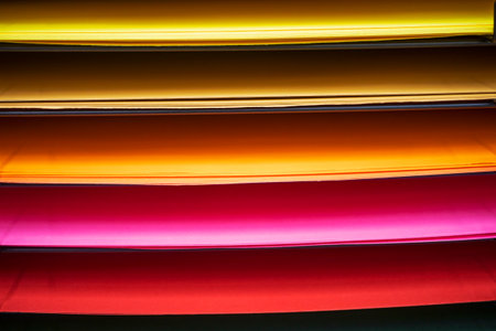 abstract background of shades from red orange to yellow of design paper laid out on the shelves.の写真素材