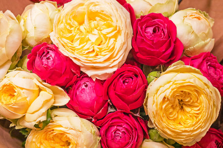 delicate festive background of red and yellow roses. Women's holiday, wedding, flat layの写真素材