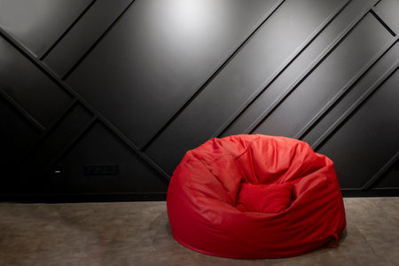 frameless red armchair near dark modern wall in office. interior mockup.の写真素材