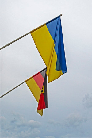 Belgian and Ukrainian flag on a cloudy day. Support for Ukraine, warの写真素材