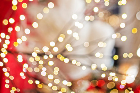 red festive background with blurry yellow lightsの写真素材