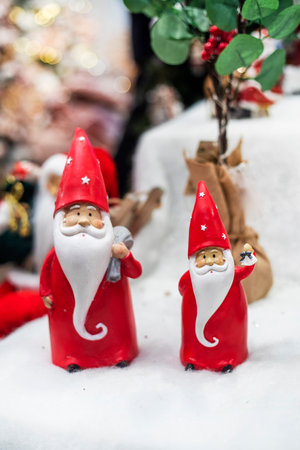 two cute Santa Clauses in red caps with gifts in the snow. Christmas holidayの写真素材