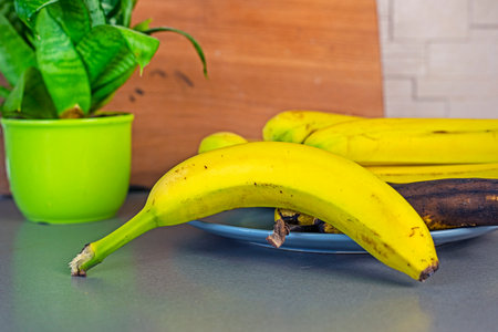 bunch of bananas and one banana lying in the kitchen. flatlayの写真素材