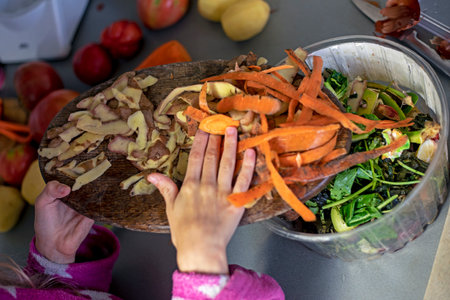 Throw carrots and potato skins into the trash. waste sortingの写真素材