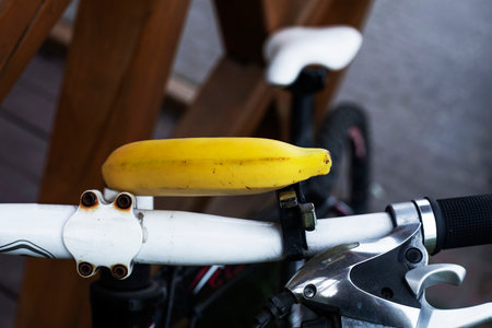 ripe yellow banana on the handlebars of a bicycle. Workout and proper nutritionの写真素材