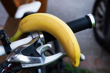 ripe yellow banana on the handlebars of a bicycle. Workout and proper nutritionの写真素材