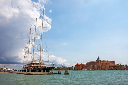 huge ship with sails near the pier of the Venetian canal in Venice, about vacations and travel