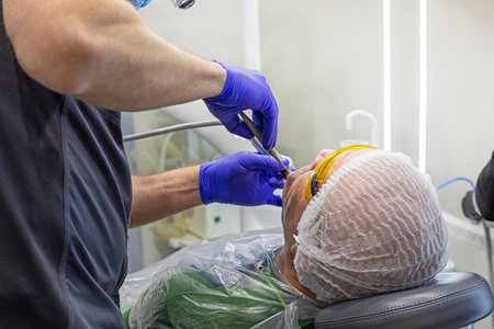 dentist injecting anesthesia into a diseased tooth before treating it