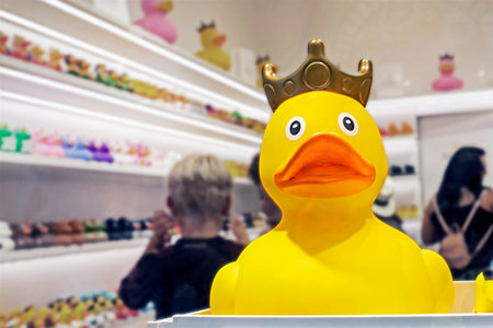 yellow toy rubber duck with a crown in a display case in a toy storeの写真素材