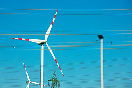 wind power plant against the background of a blue sky during the day. Crisis Saving electricity