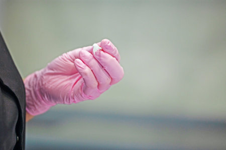 hold the nozzle with disposable pink gloves when treating teeth. Dental care and care