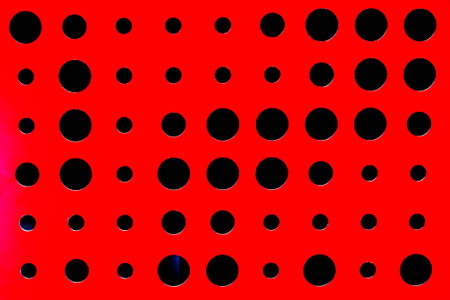 abstract red background with different round holes in modern interiorの写真素材