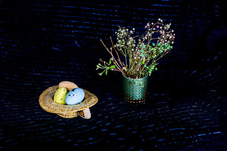 blossoming branches of a fruit tree and Easter eggs on a dark background. Easter Sunday