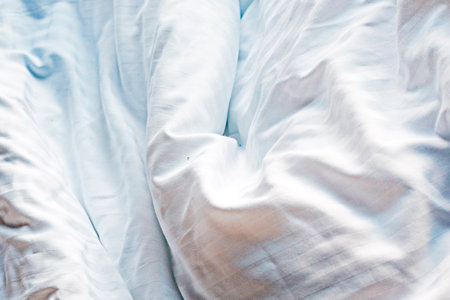 abstract textured light plain background of duvet cover fabric in bedの写真素材