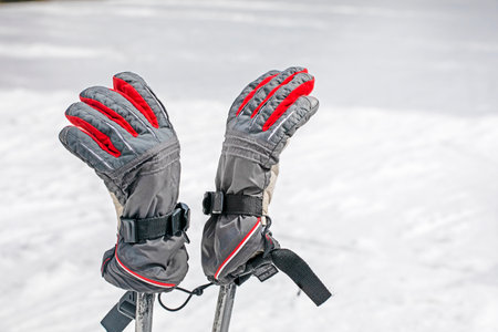 hiking poles with gloves on a flat snowy slope on a sunny day. active recreationの写真素材