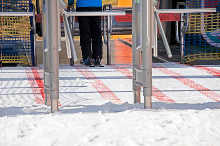 skier entering the ski lift in the morning. Active family vacation
