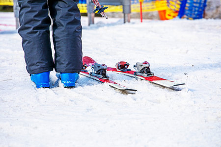 skier stands near the entrance to the ski lift in the morning. Active family vacationの写真素材