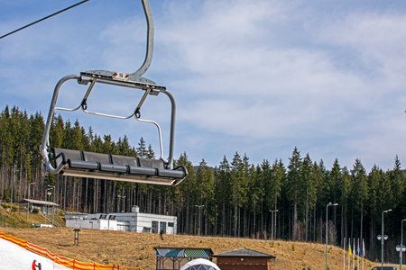 empty chairs on a ski lift on a slope where skiers ski. leisureの写真素材