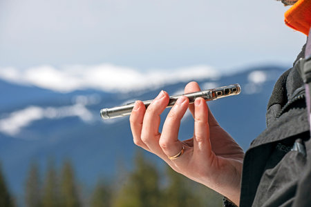 talking on the phone on a snowy slope at a ski resort. Active recreation and doing business