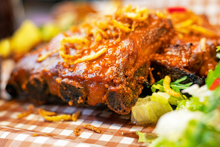 pork thighs in sauce with salad, arugula. view from above