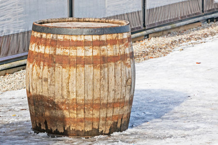 huge wooden barrel for drinks in the snow. Farming and winemaking