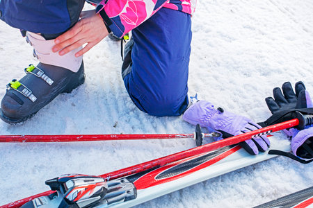 skiers re-strap their boots for a moderately difficult ski slope. Leisureの写真素材