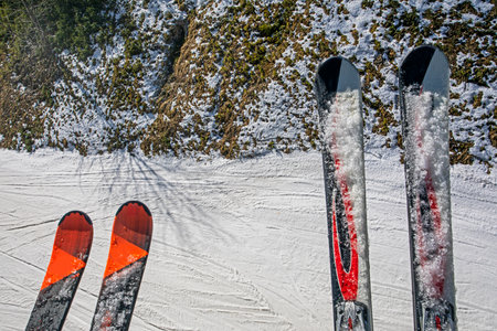 skis of mother and son against the background of a ski slope. Active school holidaysの写真素材