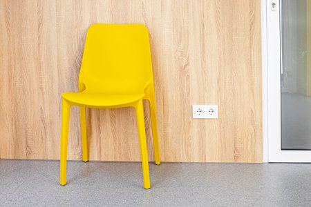 empty yellow chair near the door. Reception at the doctor. Taking care of your healthの写真素材