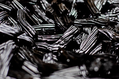 background of black chewing candies with licorice. medicinal sweetsの写真素材