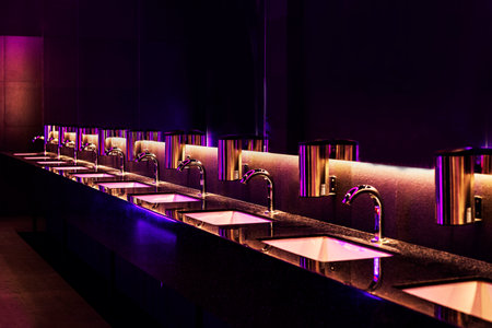 modern interior with sinks and faucets with purple lightingの写真素材