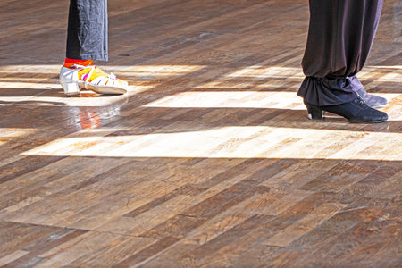 girl is training with a teacher to dance a standard program in ballroom dancingの写真素材