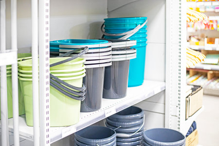 multicolored buckets for containers and cleaning on shelves in the supermarket