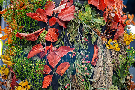 abstract background of ikebana with dried flowers, grass and roots and bark. decorative interior in...