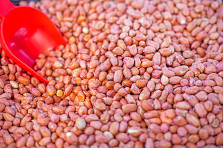 abstract background of peeled ripe peanuts by weightの写真素材