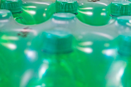 water from the spring packed in plastic green containers in the supermarketの写真素材