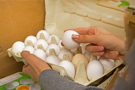 hold a container with chicken white eggs. Preparation for the holiday, economic crisis