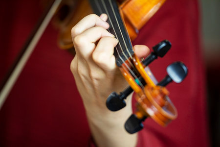 play the violin with the left hand. Correct positioning of the hand and fingers on a musical instrumentの写真素材