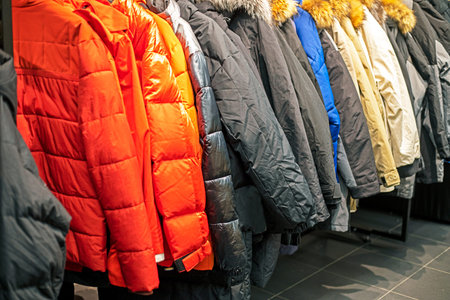 Stylish men's sports jackets and down jackets in a sports storeの写真素材