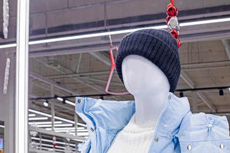 stylish light women's winter hat on a mannequin in a supermarket before Christmasの写真素材