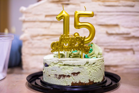 15th birthday with gold numbers on a pistachio cake. Birthday. Celebrate anniversaryの写真素材