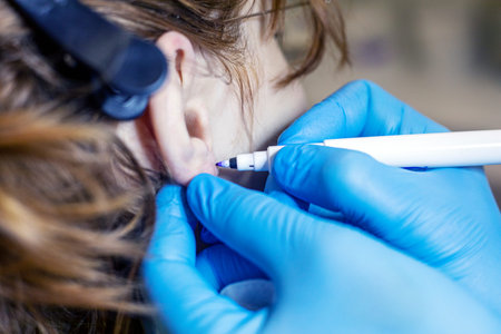 beautician in blue gloves marks the spot where the ears will be pierced. Style and beauty
