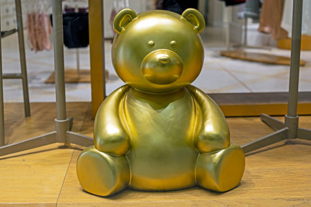cute bronze figurine of a sitting bear in the interiorの写真素材
